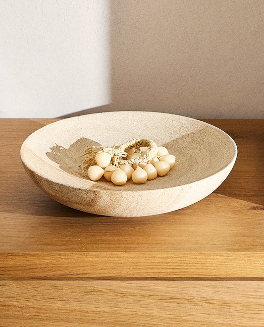Beige bowl with accesories on a table