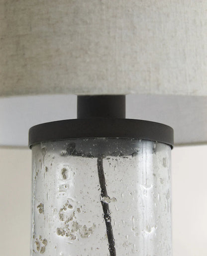 Closeup of the middle part of a lamp with glass base