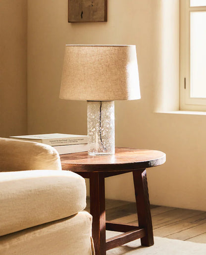 Lamp with glass base on a table